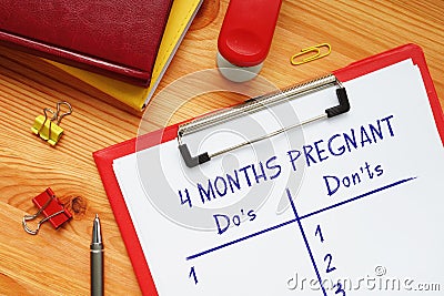 4 MONTHS PREGNANT Do`s and Don`ts phrase on the sheet Stock Photo