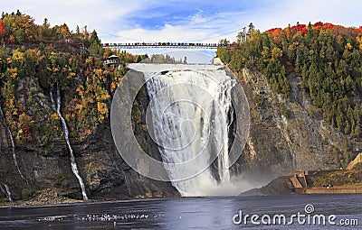 Montmorency Falls and Bridge in autumn with colorful trees, Quebec Stock Photo