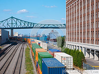 Montreal, Canada - august 19, 2018: View of old port area with train and ship in downtown of Montreal. Editorial Stock Photo