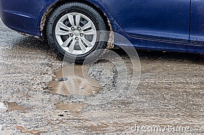 Car driving through a pothole, Montreal, Canada Editorial Stock Photo
