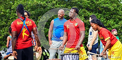 African American male and female percussionists playing djembe and dunun drums at Tam Tams festival in Mount Royal Park Editorial Stock Photo