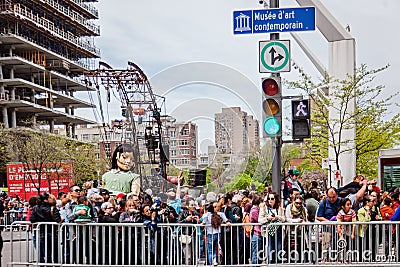 Montreal, Quebec, Canada - May 21, 2017: Sleeping little girl giant marionette and the crowd Editorial Stock Photo