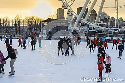 Montreal tourism - winter skating rink near the Ferris wheel. People are skating in the winter against the background Editorial Stock Photo