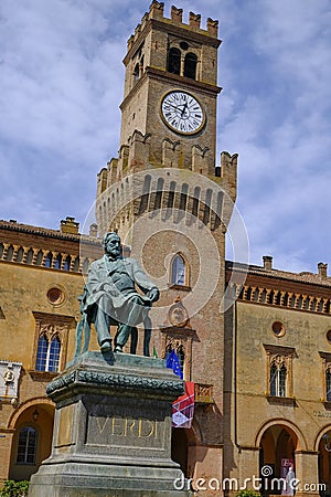 Monument of Giuseppe Verdi closeup on the square of Giuseppe Verdi across the building of theater in Busseto, Italy Editorial Stock Photo