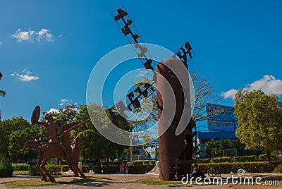 Monument Holguin, Cuba: statue of don Quixote on horse, Sancho Panza and mill Editorial Stock Photo