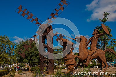 Monument Holguin, Cuba: statue of don Quixote on horse, Sancho Panza and mill Editorial Stock Photo