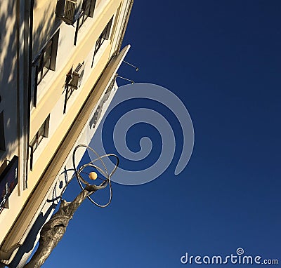 A monument with men which holding atom on a blue sky background Editorial Stock Photo