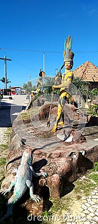 Monument representing indigenous hunting in the PataxÃ³s tribe. In the background, a cross of the first mass in Brazil. Editorial Stock Photo