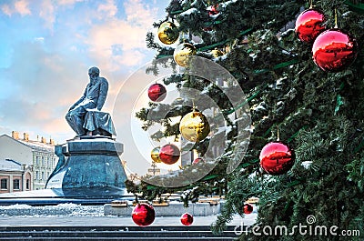 Monument to Dostoevsky at the Lenin Library in Moscow and Christmas balls on the tree Stock Photo