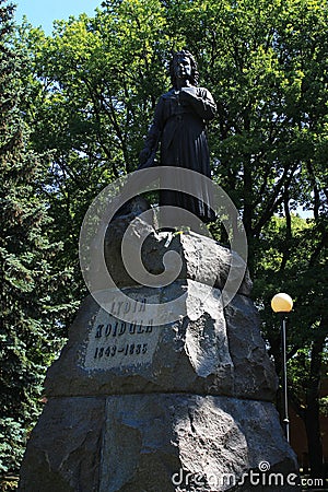 Monument to the Estonian poetess Lydia Koidula. Bronze sculpture of a woman with a book pressed to her chest on a high pedestal Editorial Stock Photo