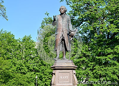 Monument to Immanuel Kant against the background of young foliage. Kaliningrad Editorial Stock Photo