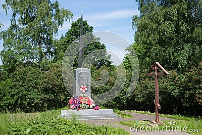 Monument to soldiers who died during the great Patriotic war, and a memorial Orthodox cross on a sunny June day Editorial Stock Photo