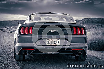 Monument Valley, Arizona, USA - Ford Mustang American muscle car stylized in black and white with red accent tail li Editorial Stock Photo