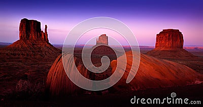 Monument Valley Landscape with Purple Skies andRed Rock Formations Stock Photo