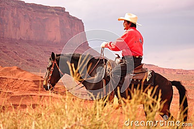 Monument Valley , Utah - September 12: Monument Valley Tribal Park in Utah USA on September 12, 2011. Cowboy on horse in famous tr Editorial Stock Photo