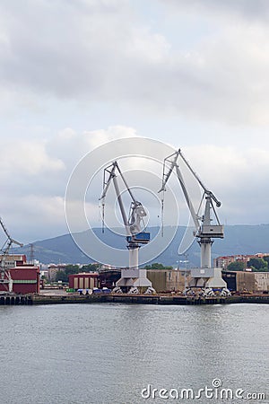 Monumental Cranes in Shipyard, surrounding the city. Stock Photo