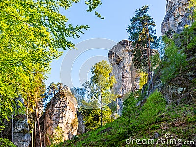 Monumental sandstone rock formation in the miidle of spring forest of Bohemian Paradise, Czech: Cesky raj, Czech Stock Photo
