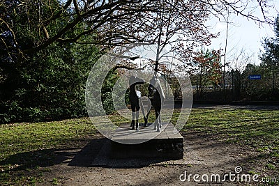 Statue with a pair of horses in the Wuhlheide park. 12459 Berlin, Germany Editorial Stock Photo