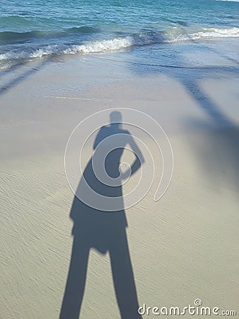 mood beach girl palm trees ocean shadow Dominican Republic Stock Photo