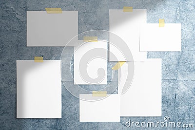 Moodboard, mood wall composition with blank photo cards and paper frames glued with adhesive tape to blue wall to display your Stock Photo