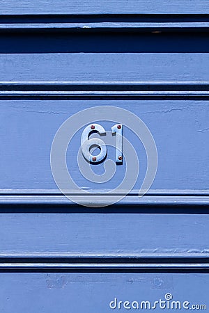 House number 61 with horizontal lines in blue Stock Photo