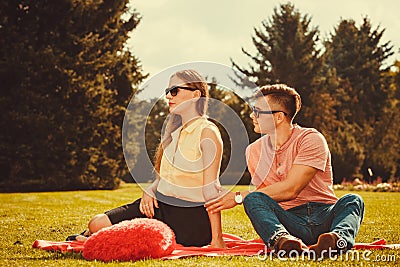 Moody girl with boyfriend in park. Stock Photo