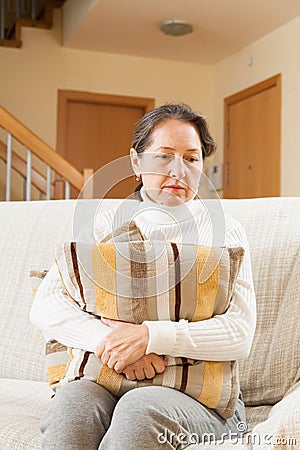 Moody senior woman Stock Photo