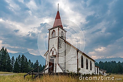 Moody skies over the former Sacred Heart Catholic Mission Church of Columbia Band First Nation, near Windermere, BC Stock Photo