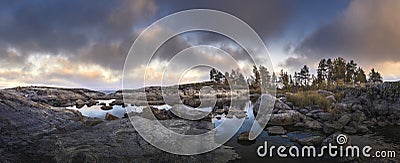 Moody sunset over northern shore with dramatic sky. Scandinavian scenic view Stock Photo