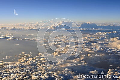 Moon above evening clouds. Stock Photo