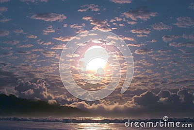 Moon and clouds create captivating atmosphere above serene ocean Stock Photo