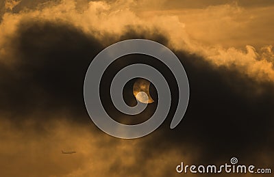 The Moon covering the Sun in a partial eclipse Stock Photo