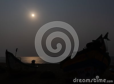 Moon light at seashore with fisherman boat shadow Stock Photo