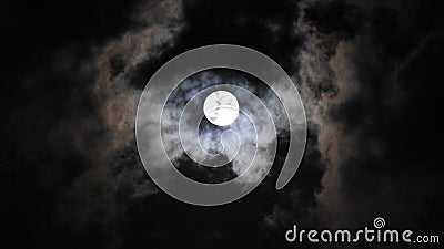 Moon. Mysterious. Mysterious. Lurking behind the clouds. Illuminating the coming rain. Alarming. Awesome. And at the same time - b Stock Photo