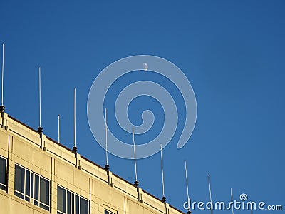 moon over the building in the daytime Stock Photo