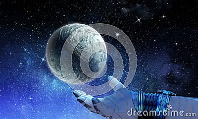 Moon planet in spaceman hand. Mixed media Stock Photo