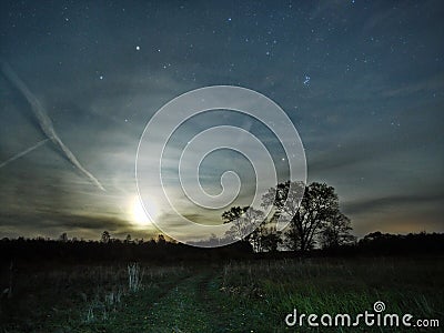 Moon rise pleiades stars and clouds observing autumn landscape Stock Photo