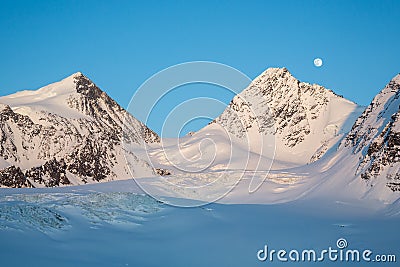 Moon Rising over Sweden Peak and Scandanavian Glacier in Alaska Stock Photo