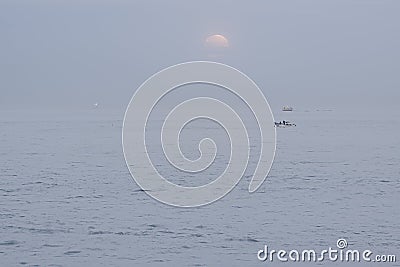 Moon set in a foggy morning Stock Photo