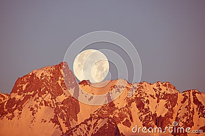 Moon Setting Over Mountain Stock Photo