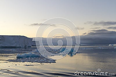 Moon in sky over tabular icebergs, Antarctic Sound Stock Photo