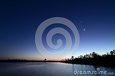 Moon, Venus, Orion over Pine Glades Lake in late evening twilight. Stock Photo