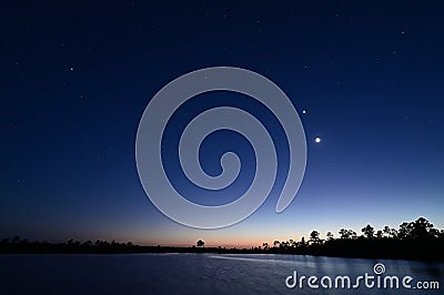 Moon, Venus, Orion over Pine Glades Lake in late evening twilight. Stock Photo