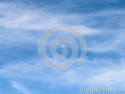 Moon Visible In Daylight Blue Sky With White Clouds Stock Photo