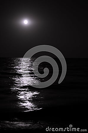 Moonlight on the sea waves. Night Moon. Long exposure Stock Photo