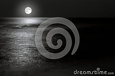 Moonlight on the waves at night in the sea on long exposures Stock Photo