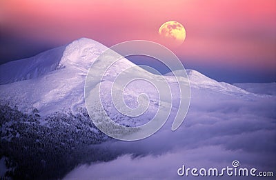 Moonrise among alpine peaks Stock Photo