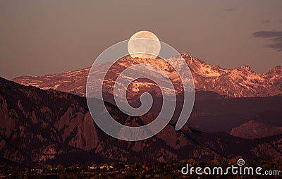 Moonset over the rocky mountains, behind Boulder Colorado Stock Photo