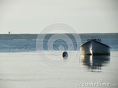 Moored boat in calm tidal water Stock Photo