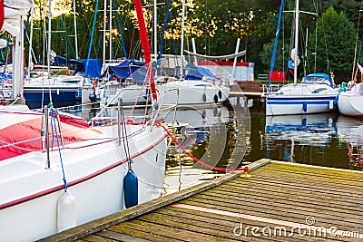 Moored sailboats on a pier calm early morning Stock Photo